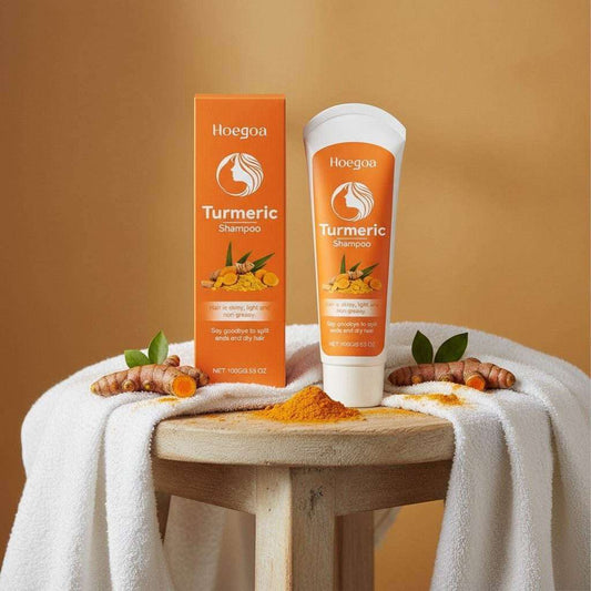 Golden Vitality Turmeric & Herbal Shampoo bottle and box with turmeric roots on wooden table