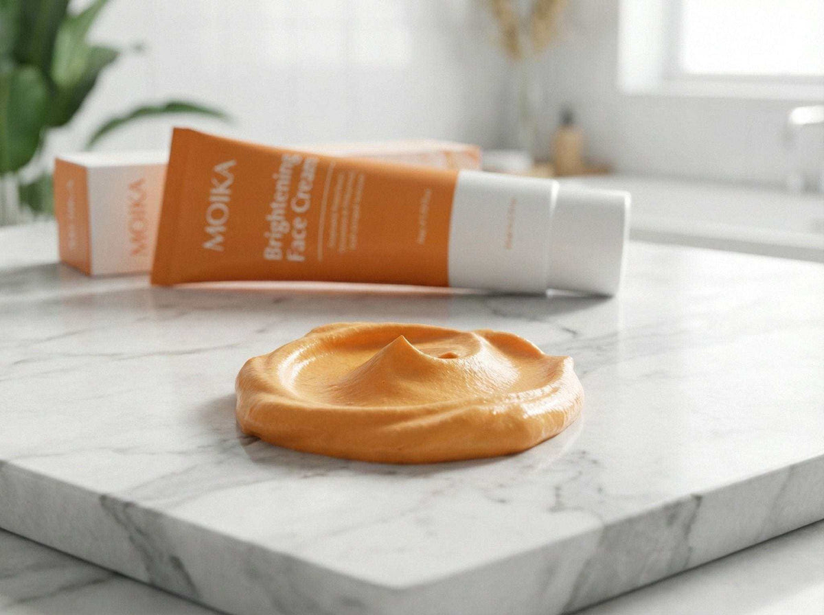 Turmeric and Niacinamide brightening face cream with creamy texture on marble surface