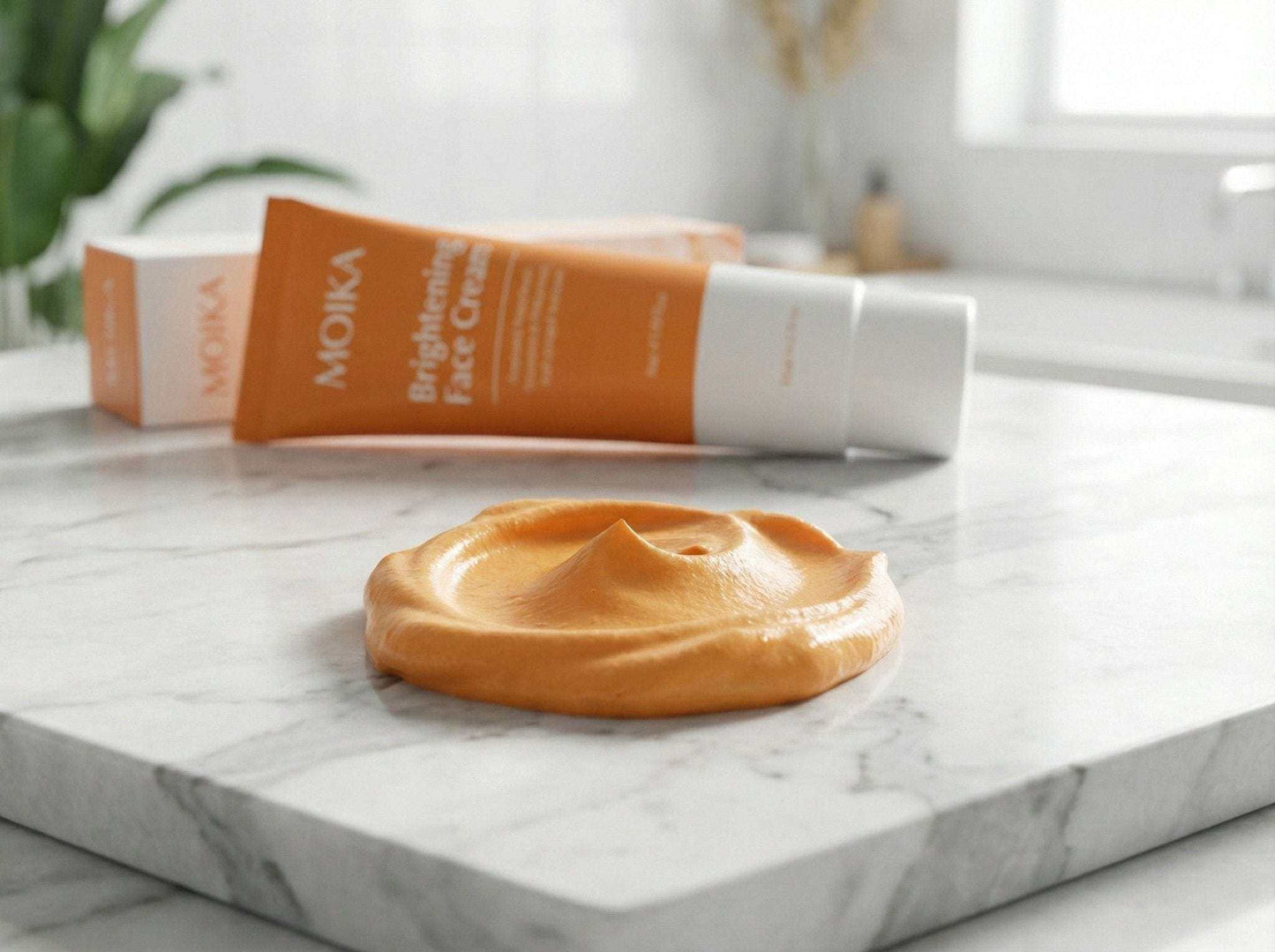 Turmeric and Niacinamide brightening face cream with creamy texture on marble surface